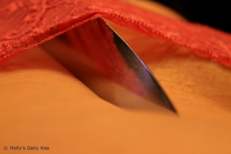 knife digging into flesh cutting off panties