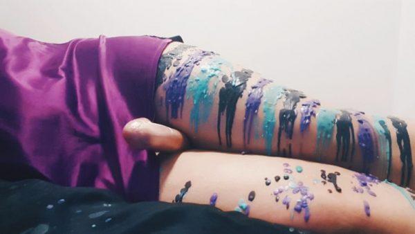 different coloured wax dripped onto womans legs, wax play