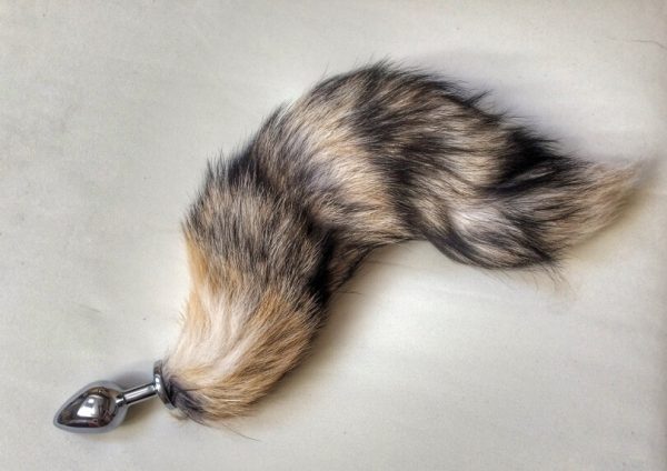 furry tail attached to metal butt plug