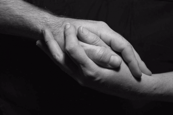 Male and female hands reaching for each other