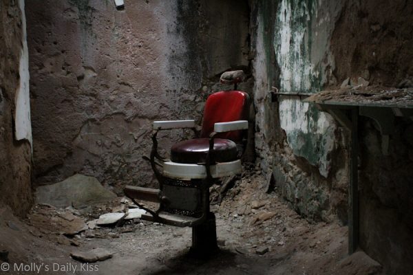 Old barbers chair in deralict prison for post about kink for things and places